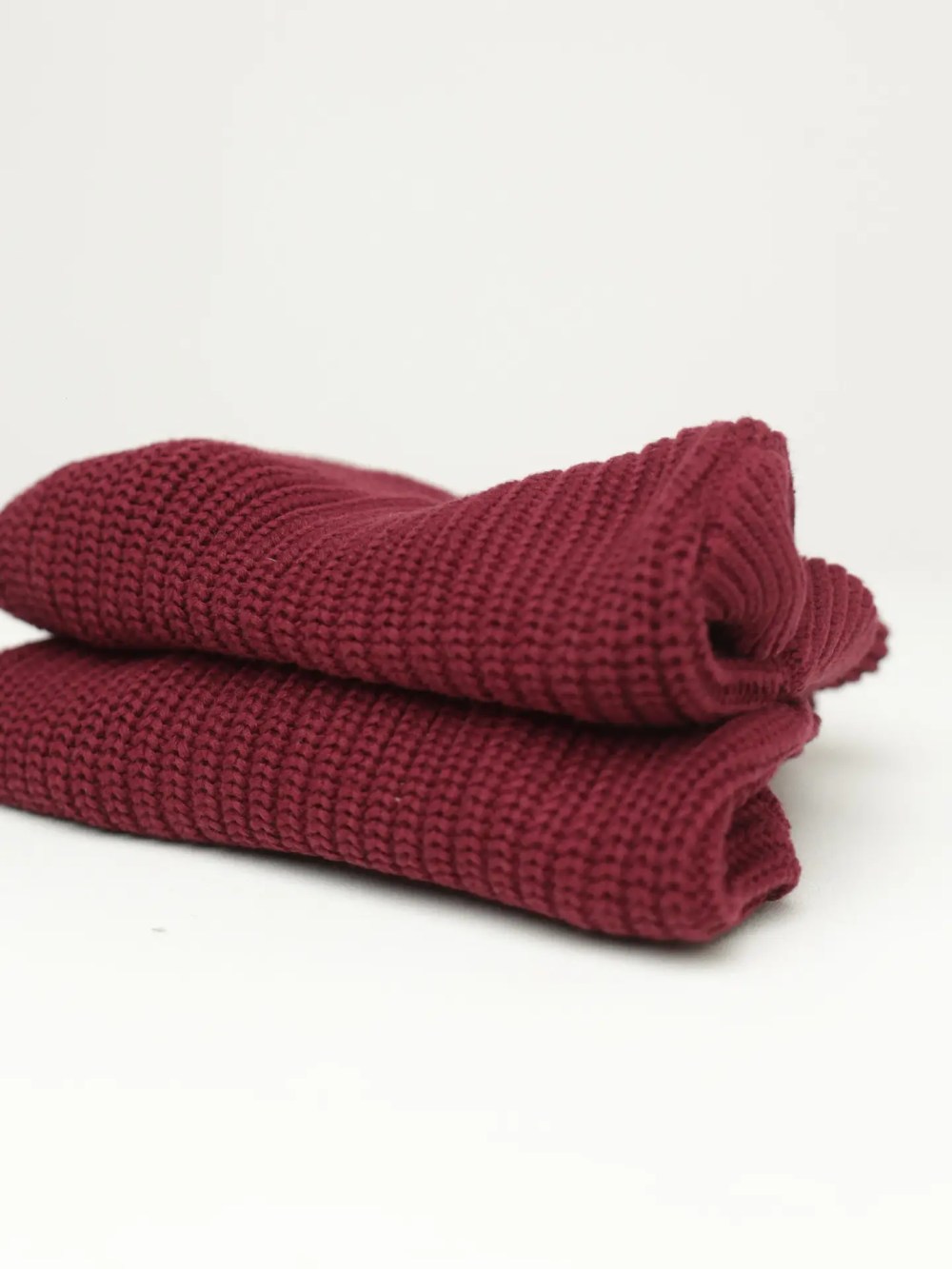 Folded burgundy knitted dog sweater made from soft premium knit fabric.