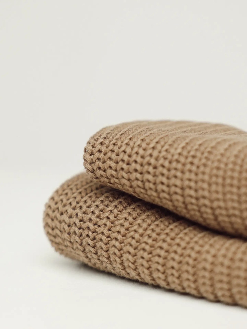 Folded sand knitted dog sweater made from soft premium knit fabric.