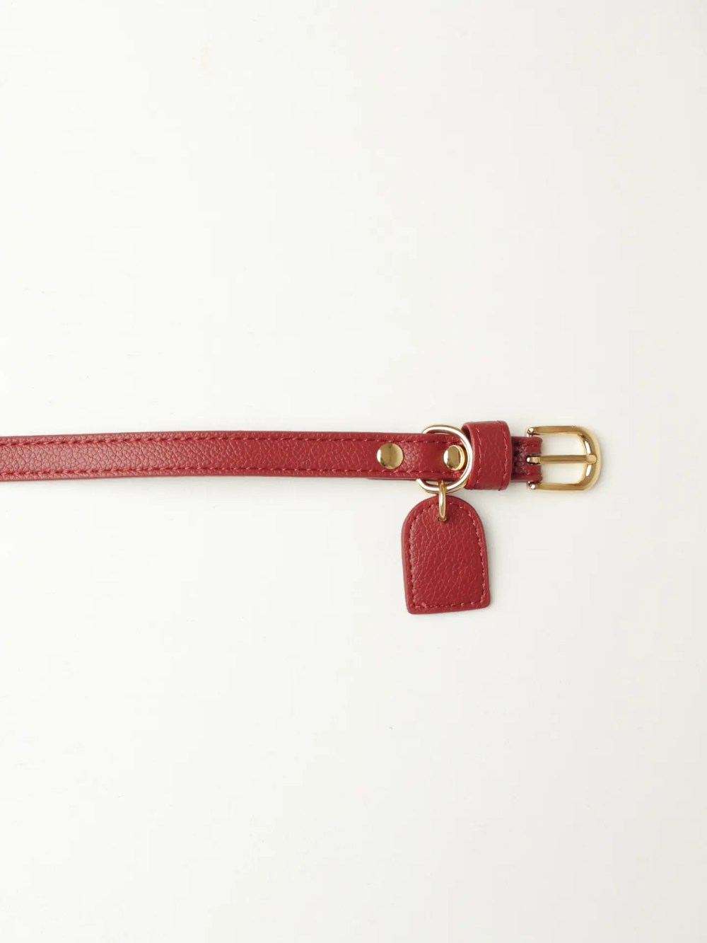 Luxury burgundy vegan leather dog collar with gold hardware.