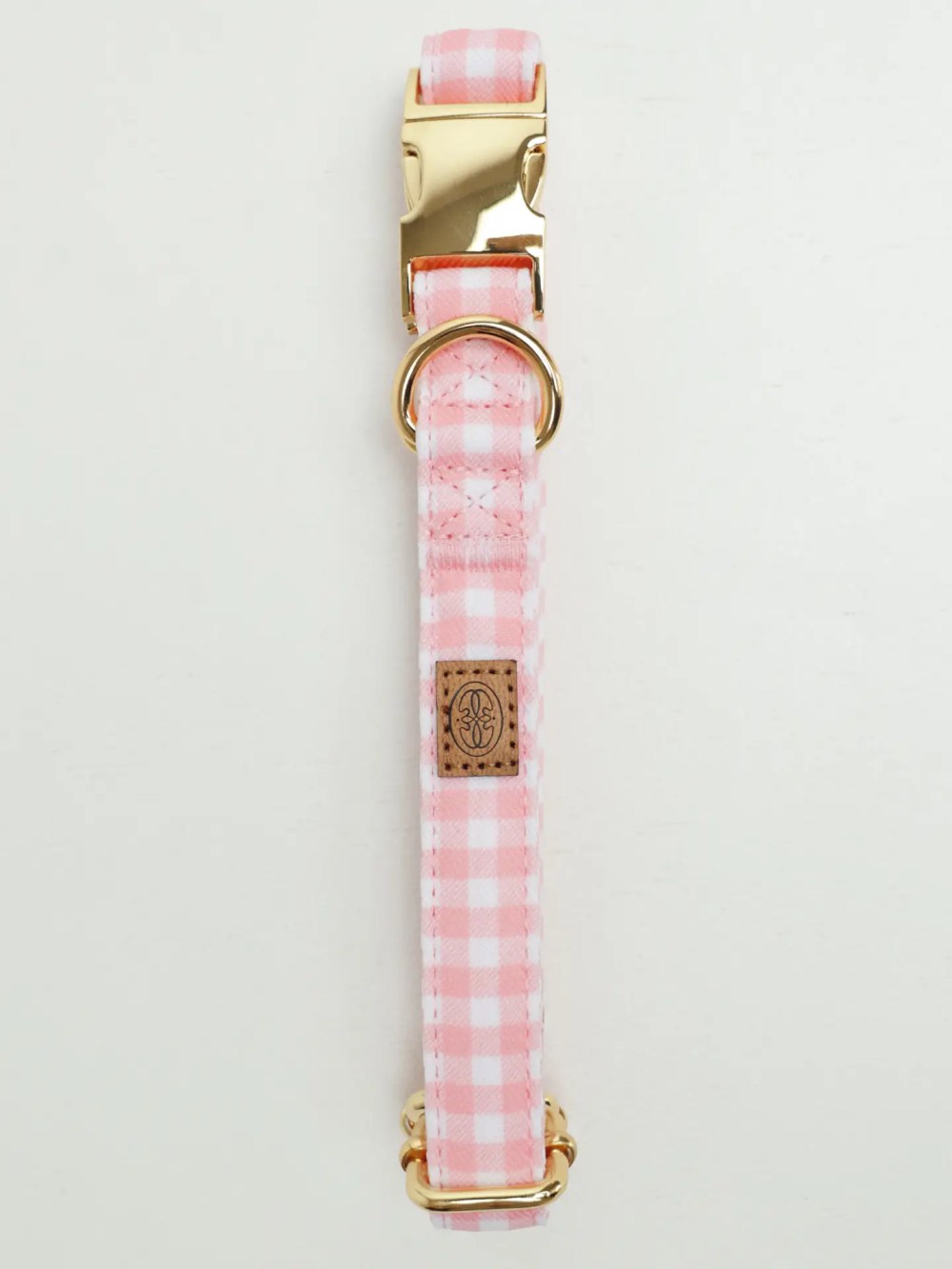 Pink gingham adjustable dog collar with gold hardware by Oliva Pet Atelier.