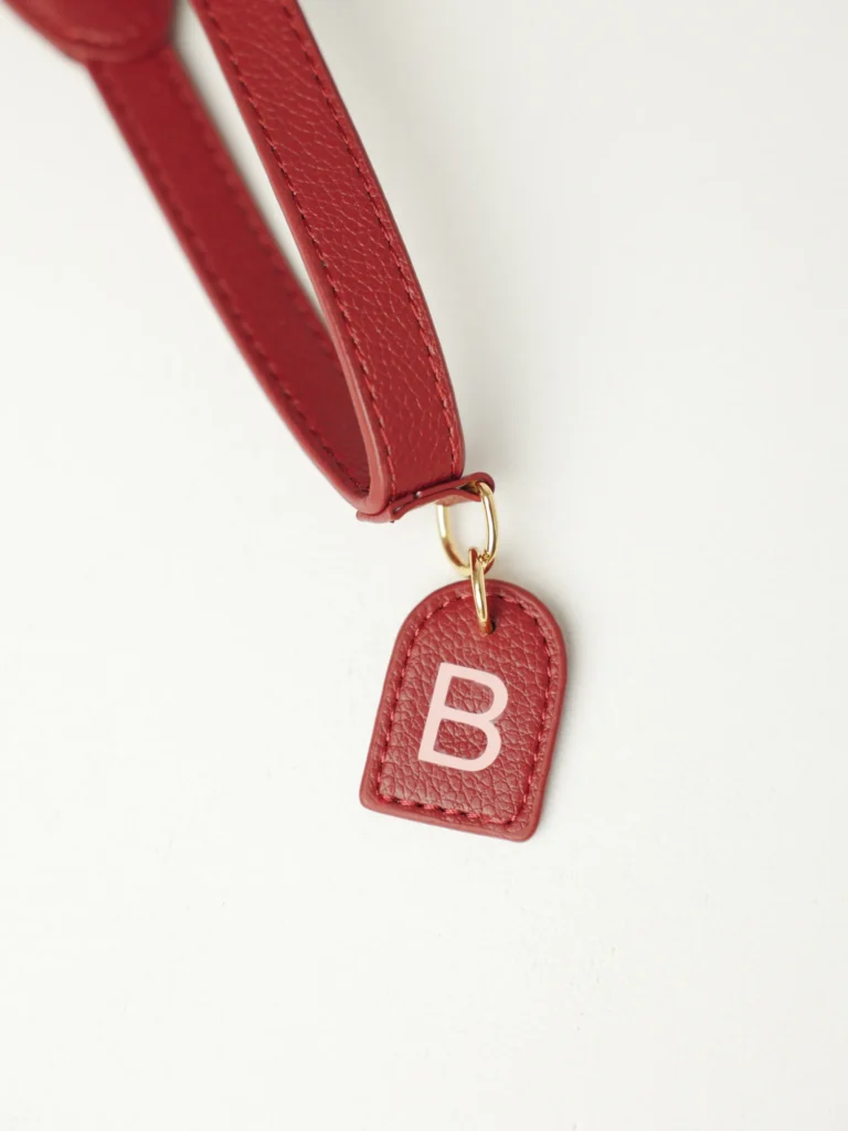 Burgundy personalised dog harness tag with the initial B
