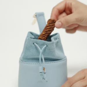 Taking a treat out of the Sky Blue leather treat bag