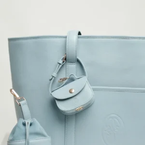 Detail of the Sky Blue leather dog carrier with the poop bag holder on the strap and the treat bag