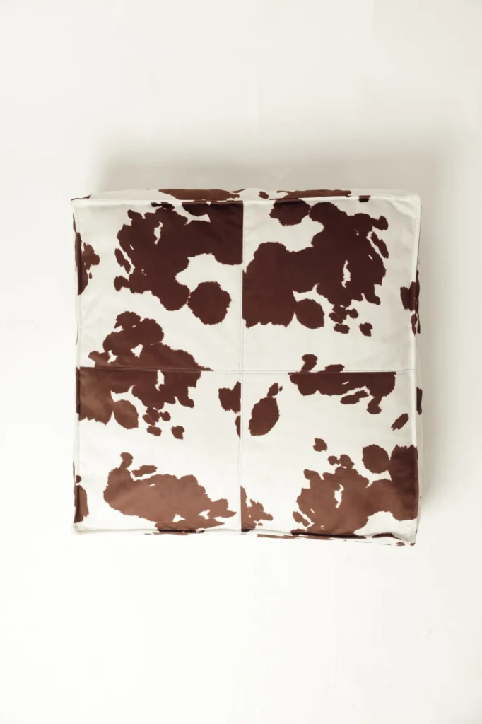 Top view of the mattress-style Moo dog bed with cow print
