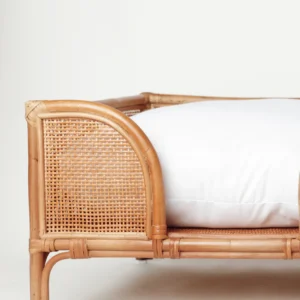 Natural rattan Oliva dog bed with a soft white cushion
