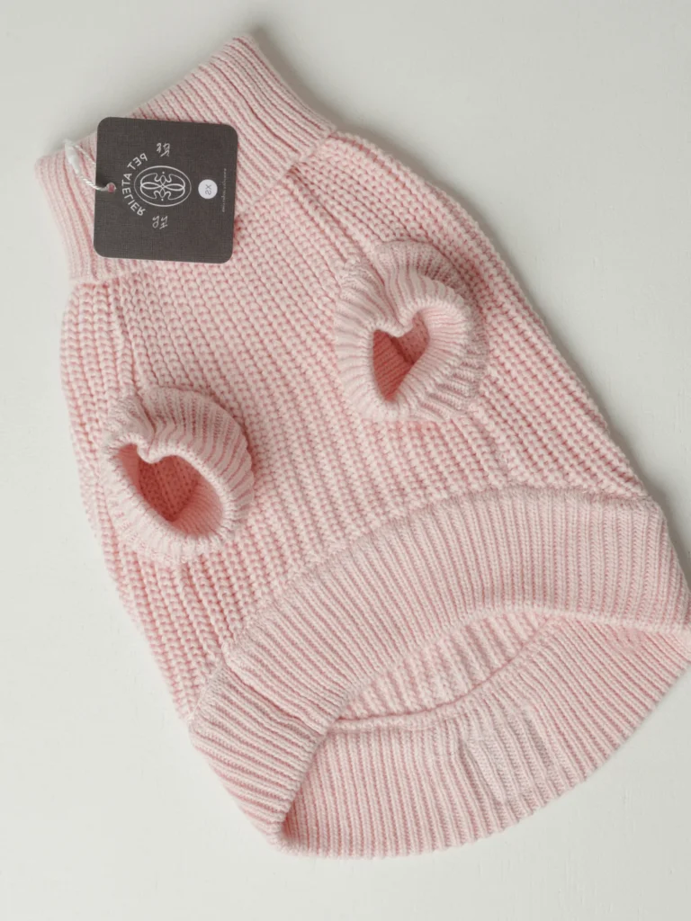 Underside of the blush pink knit dog jumper, with the leg openings and the Oliva tag