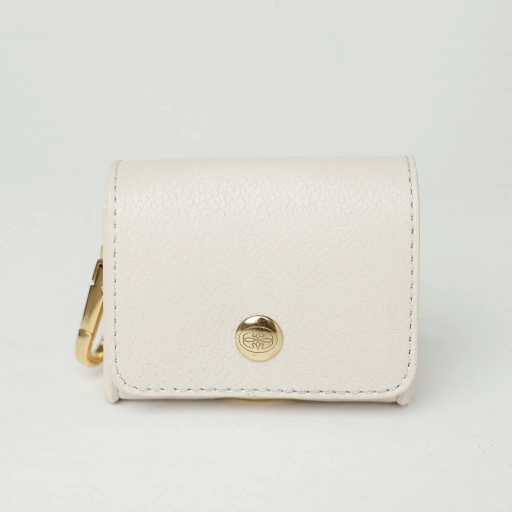 White poop bag holder with a gold-tone clasp and the Oliva press stud