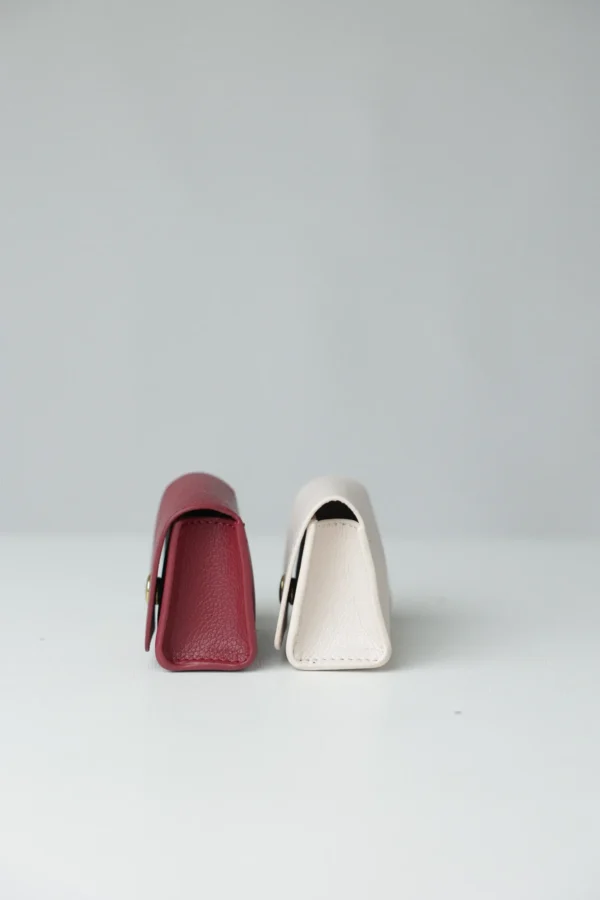 Burgundy and white poop bag holders side by side